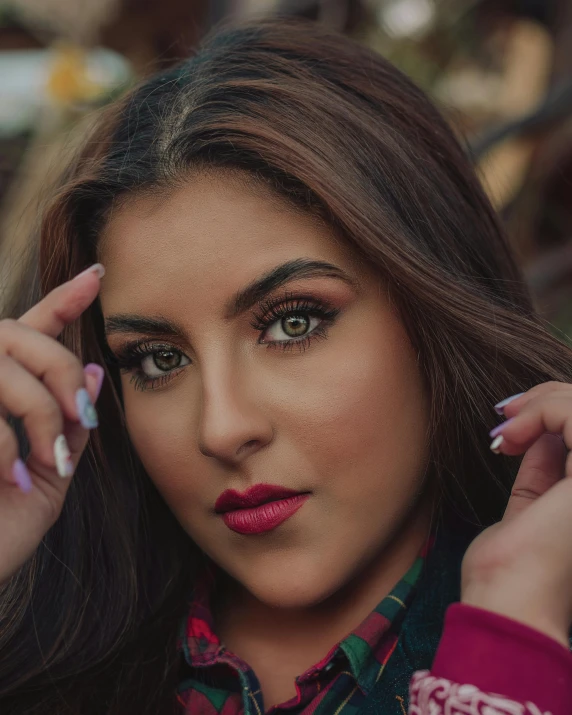 an attractive young lady wearing pink and purple lipstick and some pretty rings