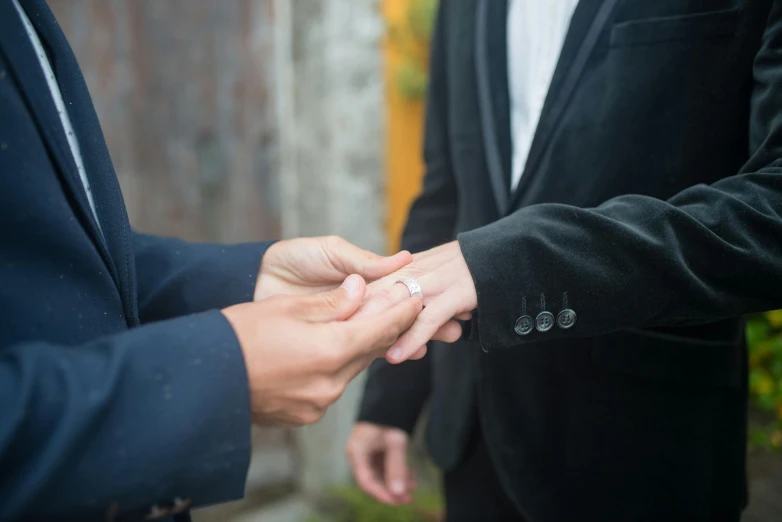 the bride and groom are holding hands