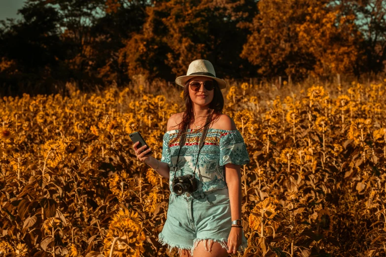 a young woman standing in a field of sunflowers