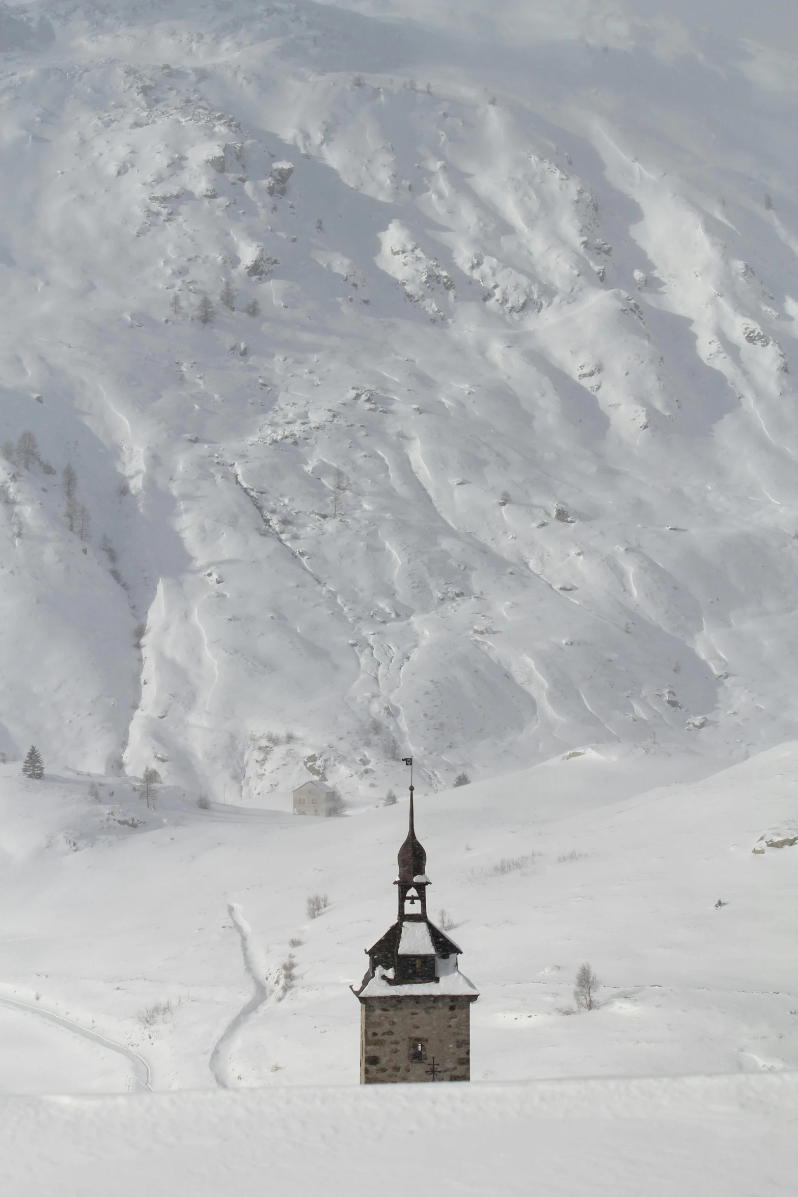 there is a small church in the snow