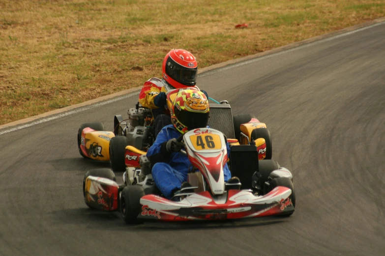 two people on a go - cart racing race track