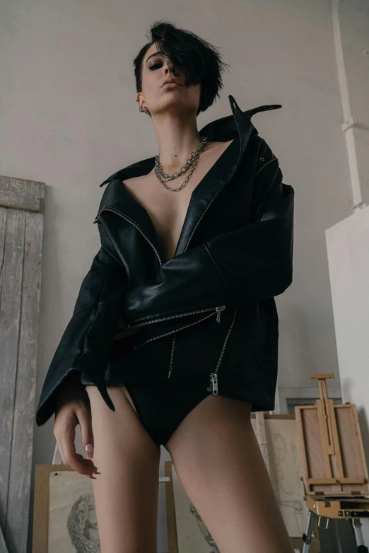 a women who is wearing a black jacket and underwear