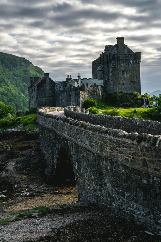 the old bridge in front of an ancient castle