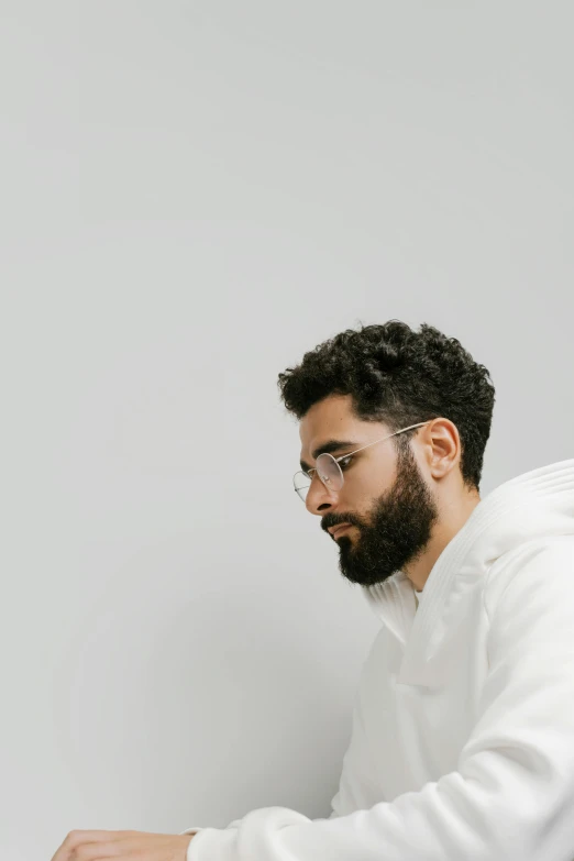 a man with a beard, glasses and a white shirt