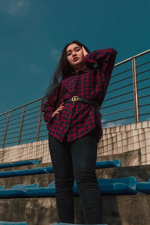 a girl wearing boots stands on a set of steps