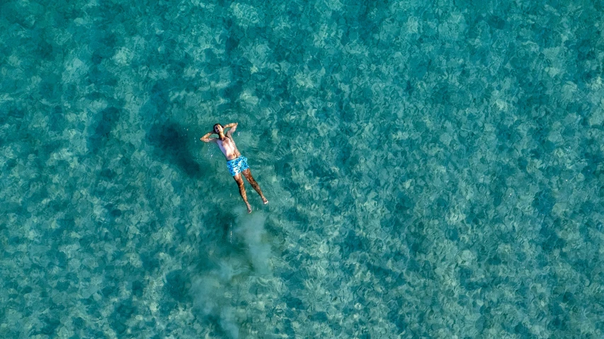 a person is floating in the water on a surfboard