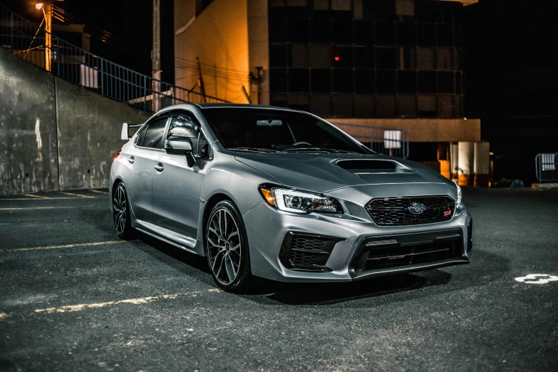 a grey car parked on the street in the dark