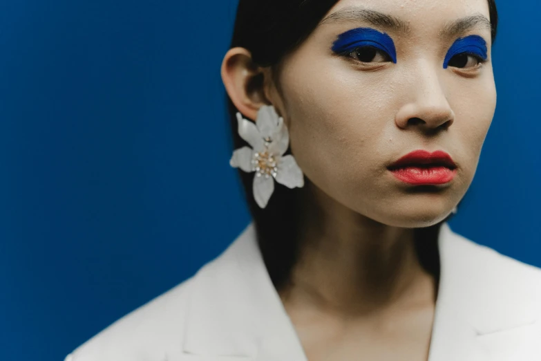 a beautiful young lady with bright blue makeup