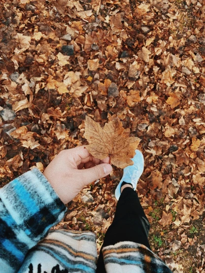 the woman is standing in leaves near her foot