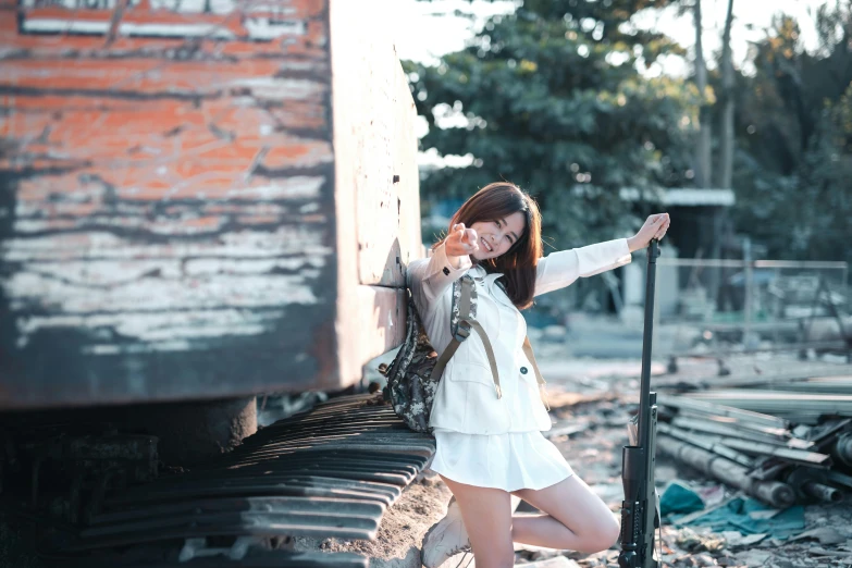 a girl is standing with luggage and posing for a po