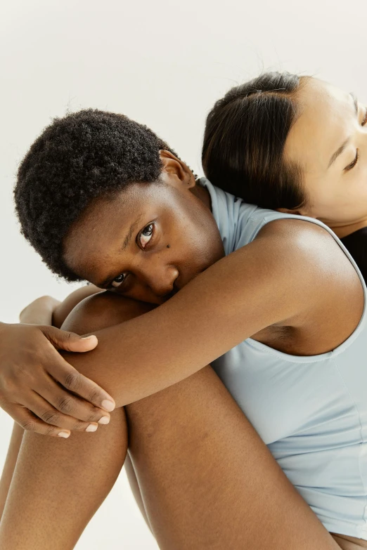 a woman with her leg in her hand while hugging a lady's 