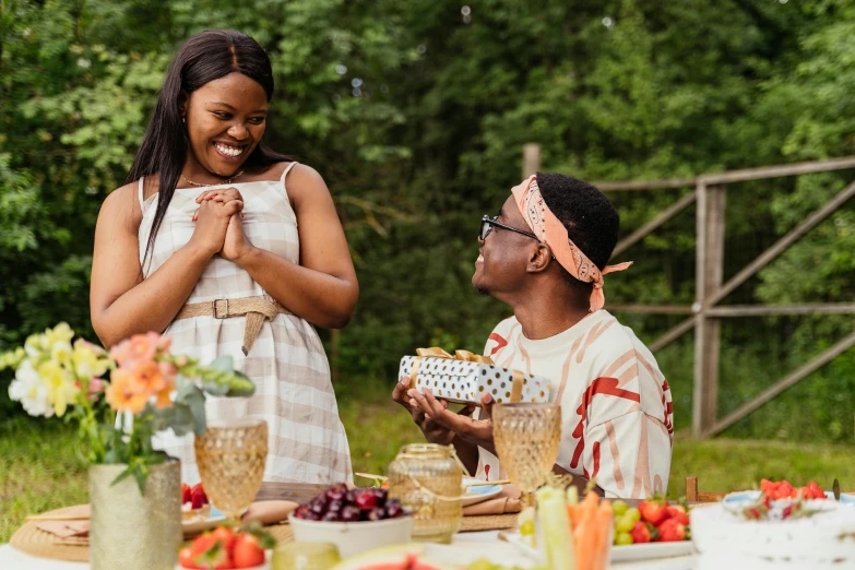 man and woman with food in a park setting