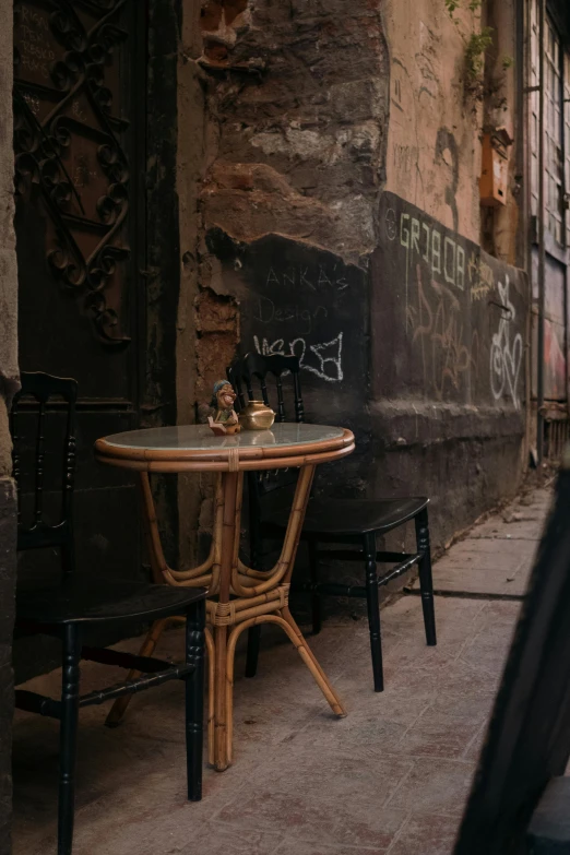 a table and bench outside of a building