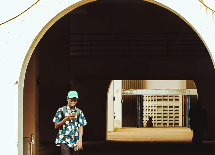 there is a young man that is standing next to a building