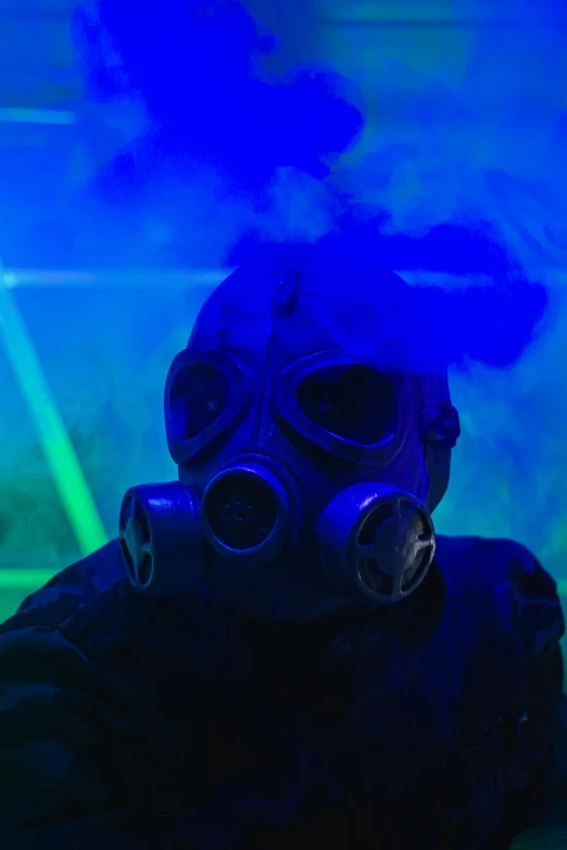 a man with a gas mask standing against a green background