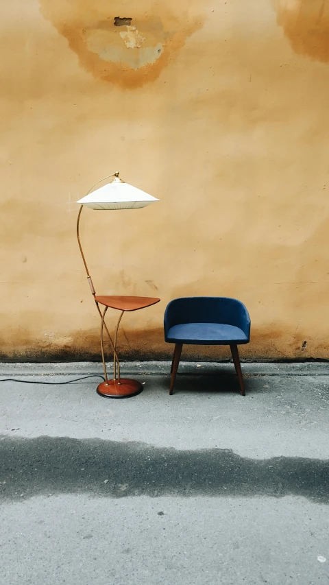 a blue bench sitting under a white umbrella