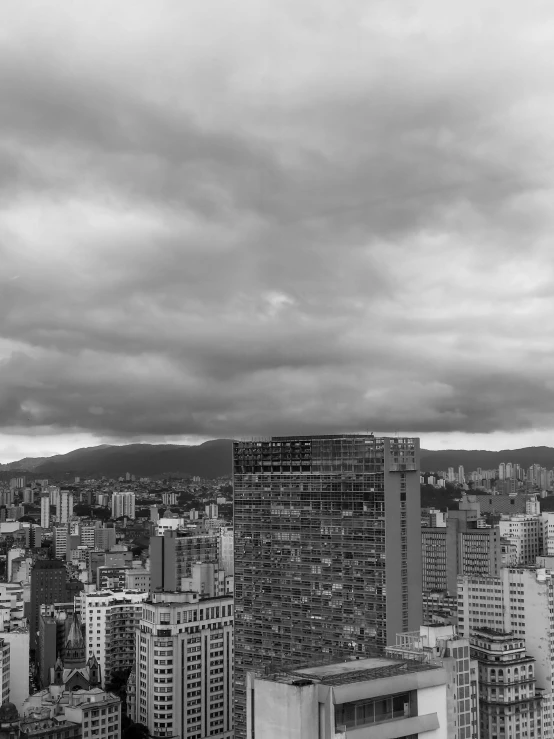 black and white pograph of city with cloudy sky