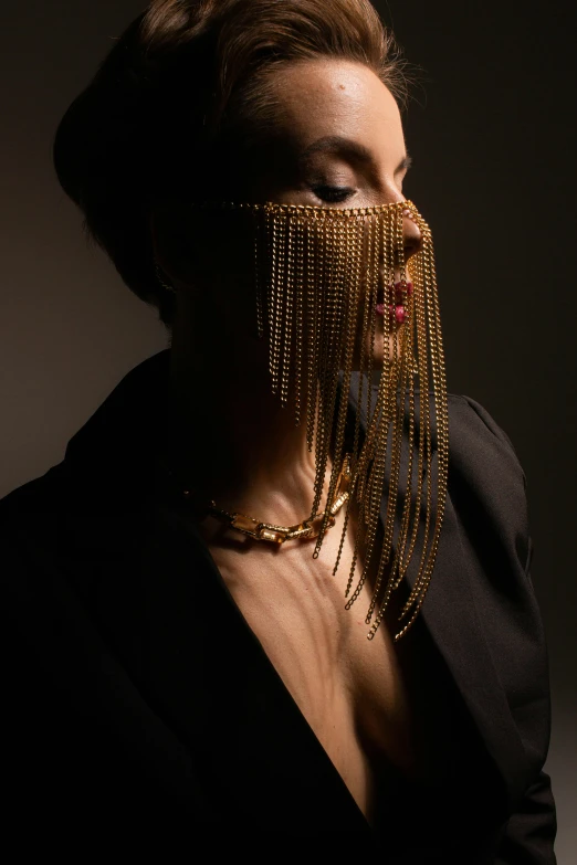 a woman with golden chains around her mouth