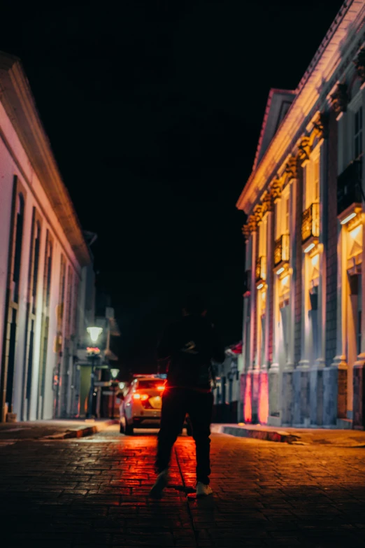 an older man stands on the street near a building