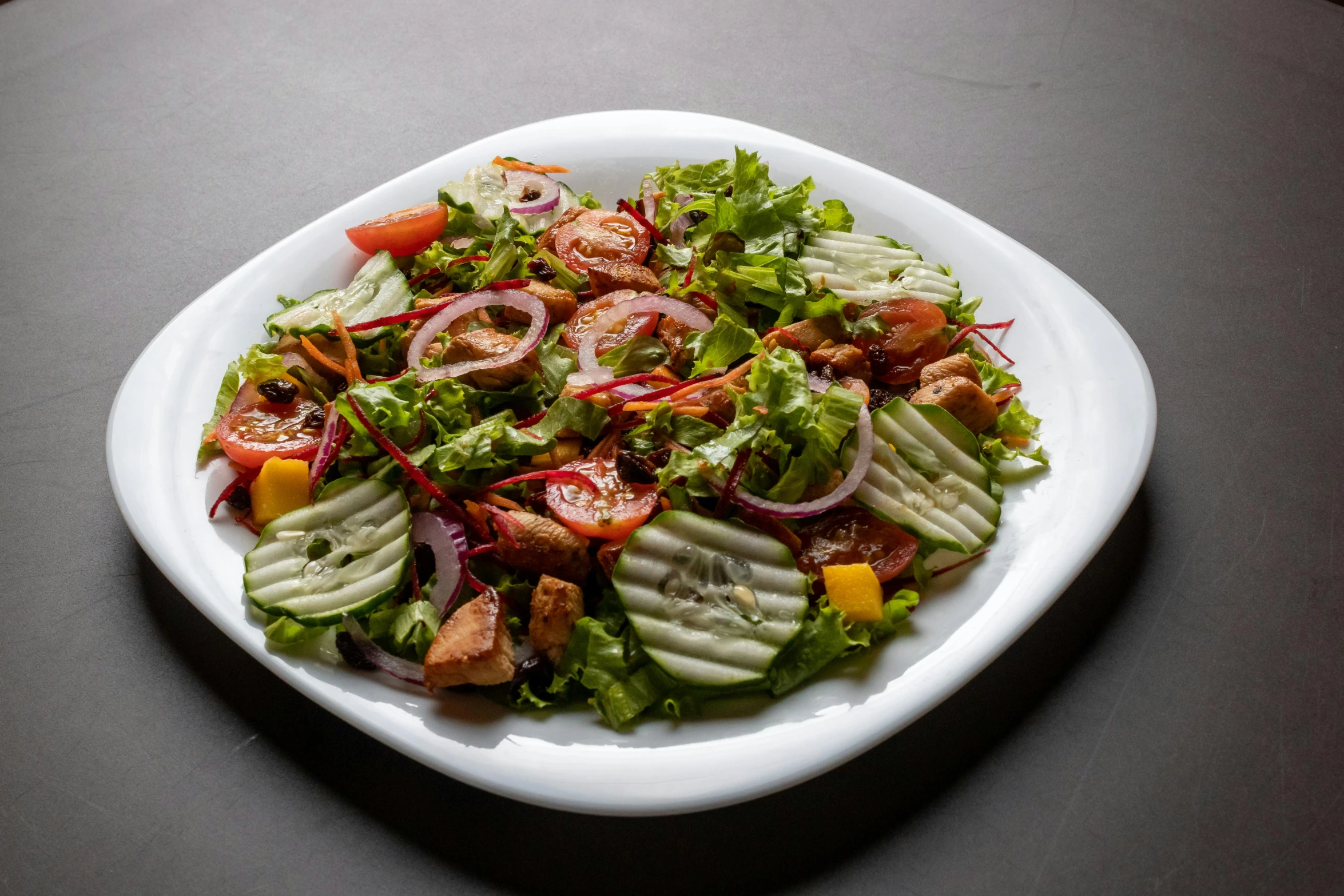 a white plate with food and dressing on it