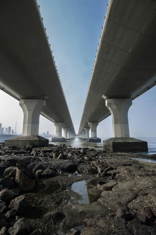 an overhead view of a long bridge with water under it