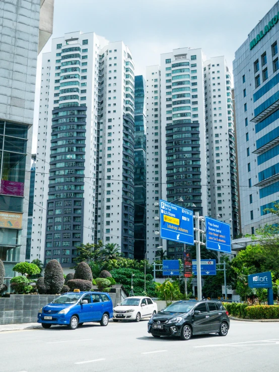 several cars parked in front of tall buildings