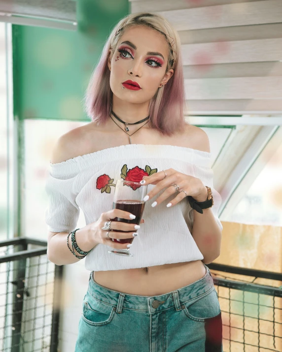 a woman wearing white clothing and pink hair holding an ice cream