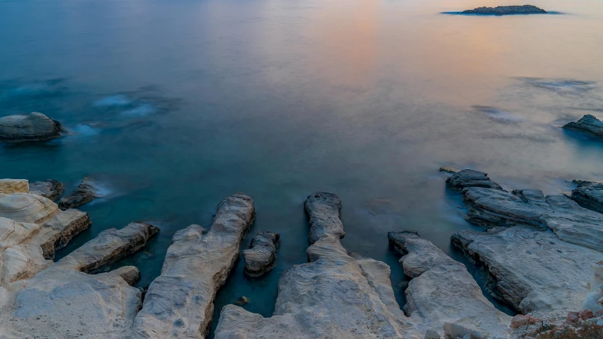 an area with rocky shores and water at sunset