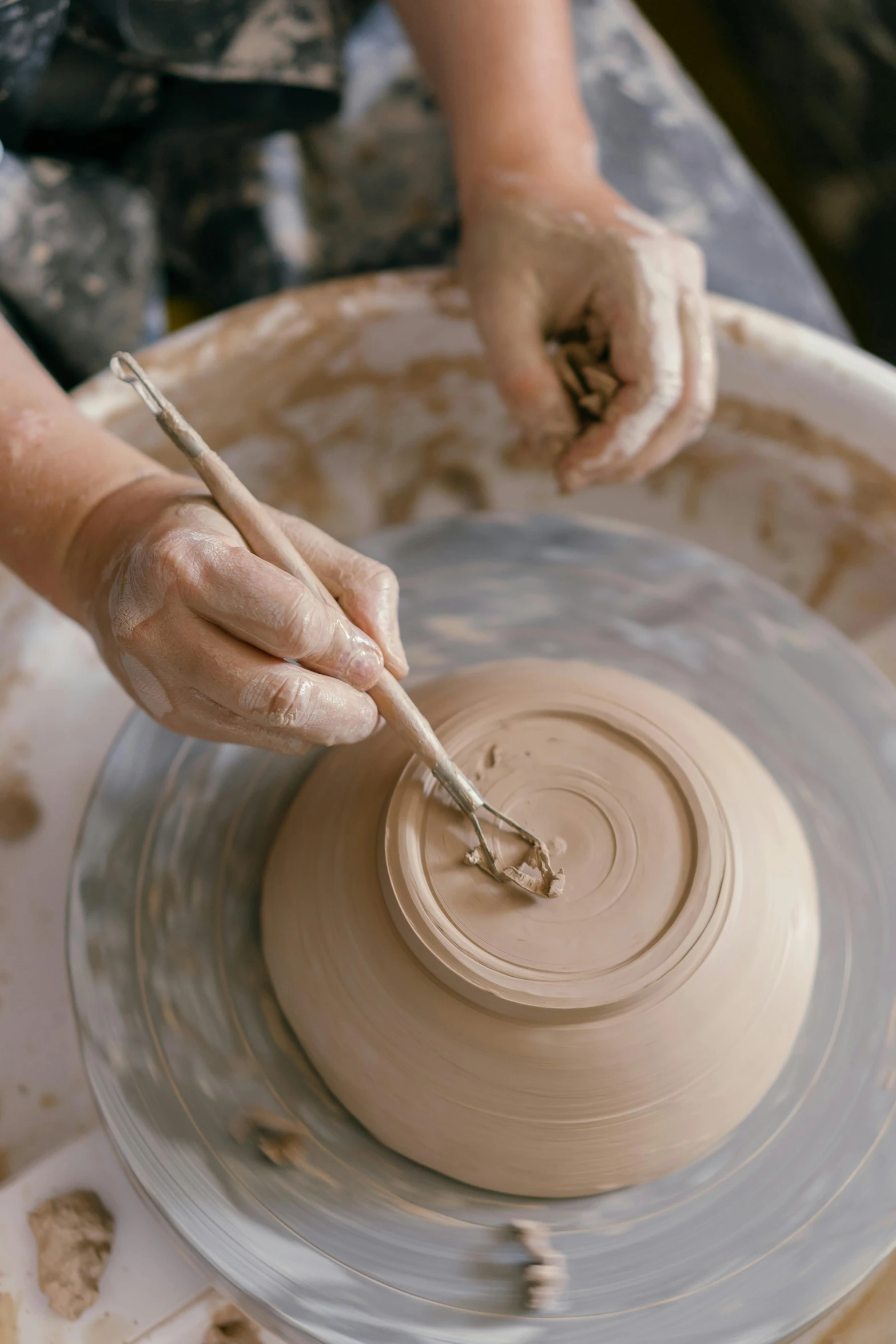 a pottery teacher is working on a wheel