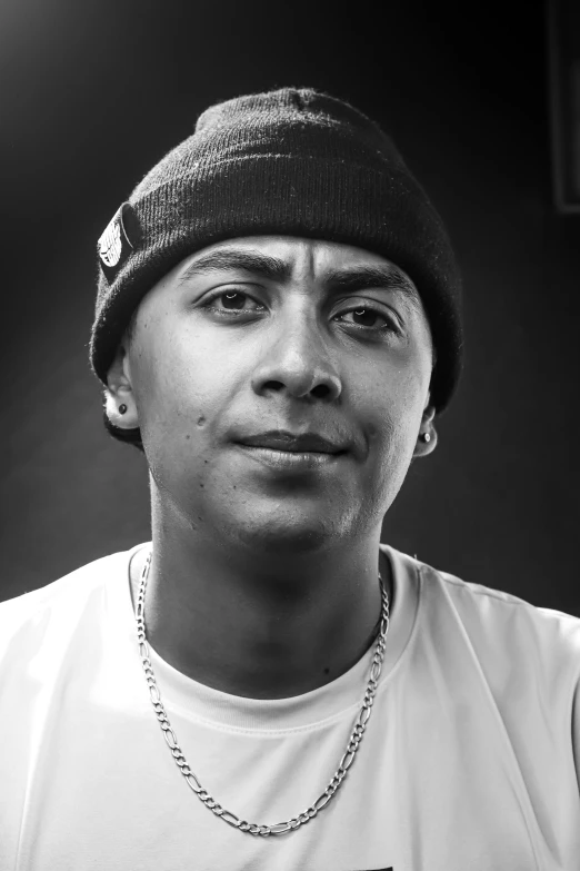 black and white po of man wearing beanie, looking into the camera