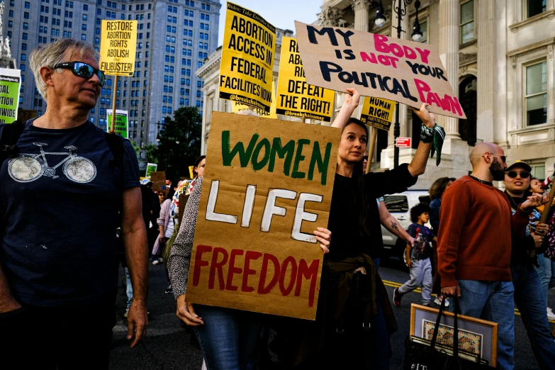 many people are holding up signs in the street