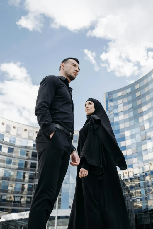 a man and woman in hijab standing close together