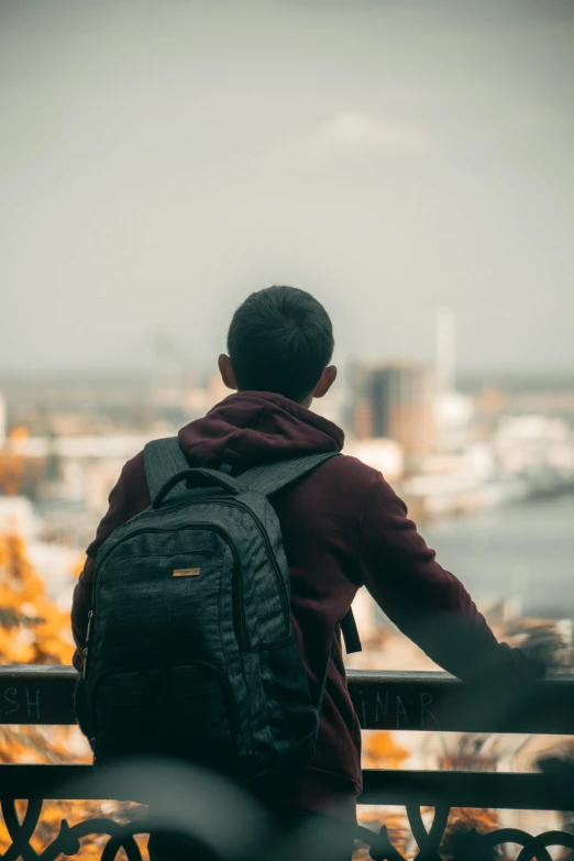 a young man sitting on a park bench