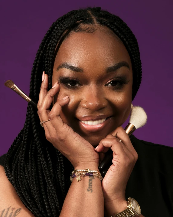 woman with multiple brushes smiling for camera