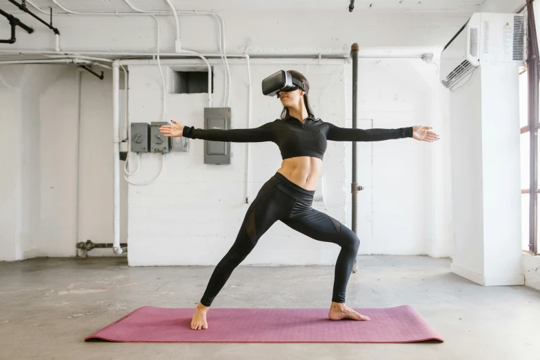 a woman doing a yoga move while holding her arms out