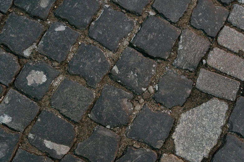 this is a cobblestone road with some white spots on it