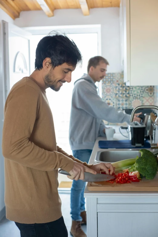 a man  vegetables on top of a kitchen counter