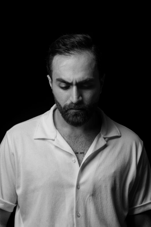 black and white image of man wearing polo shirt