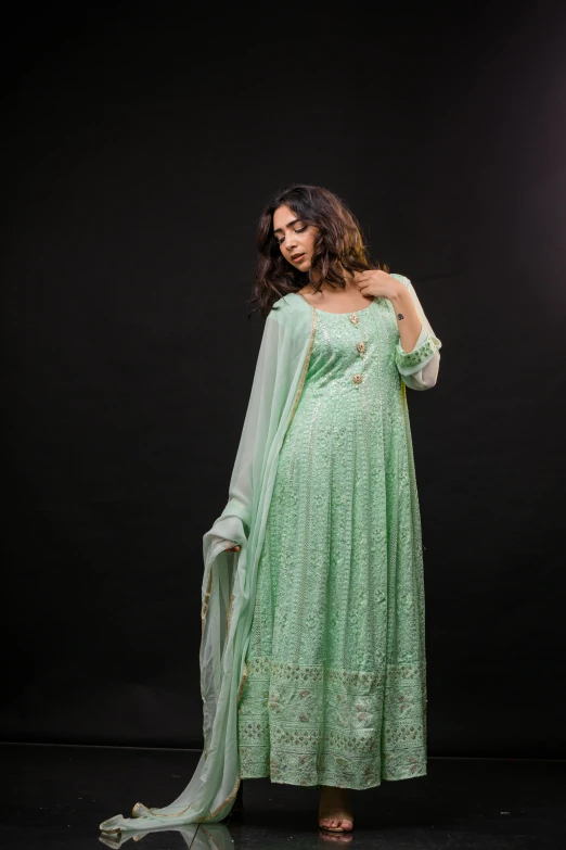 a woman in green clothing posing for a po