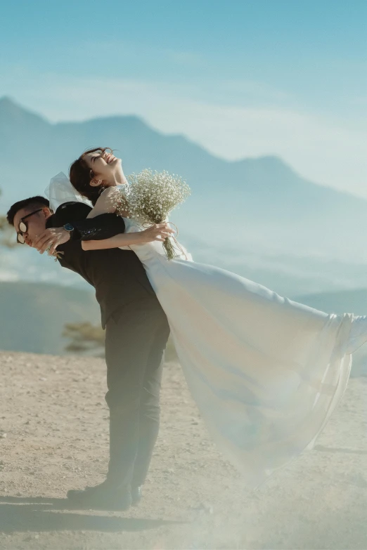 a couple of people holding soing with mountains in the background