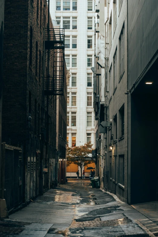 an empty street leading into two tall buildings