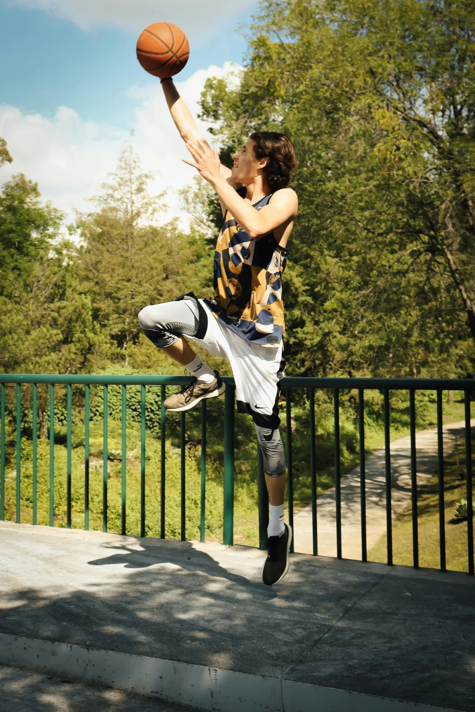 a man standing on the steps and shooting a basketball