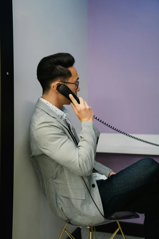 a man sits and talks on the phone