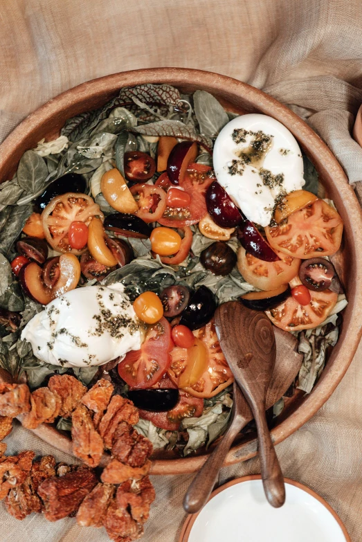 a wooden bowl filled with salad on top of a table