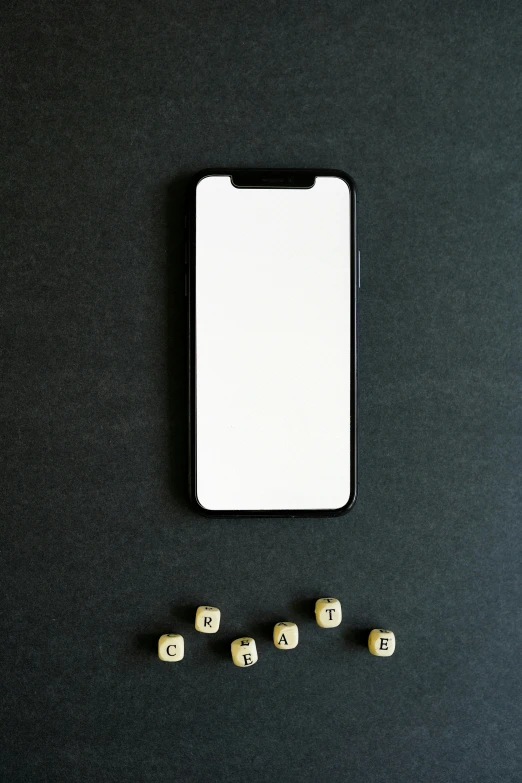 the word game blocks are placed next to a cell phone