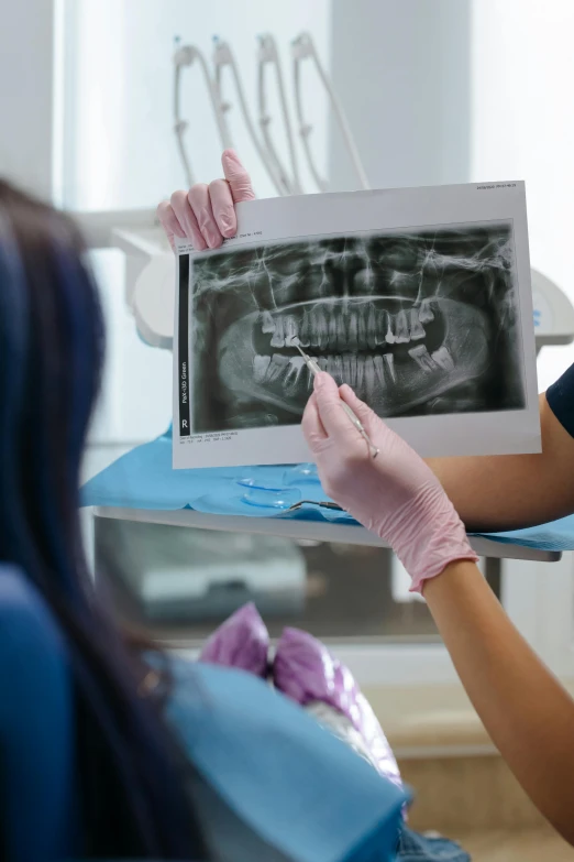 an employee demonstrating the results on a smile