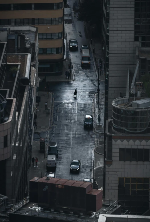 a city street in the rain next to buildings