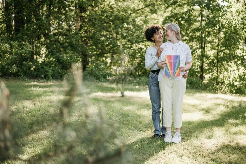 two people are emcing each other while they are in the grass