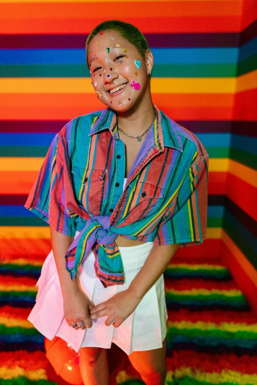 a woman wearing a colorful shirt and white skirt