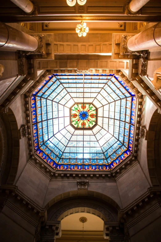 a very fancy looking stained glass window in a big room